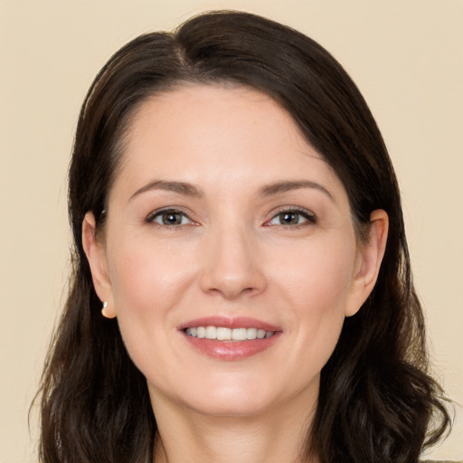 Joyful white young-adult female with long  brown hair and brown eyes