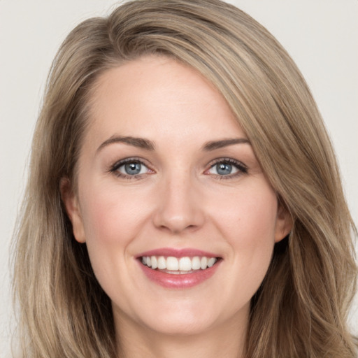 Joyful white young-adult female with long  brown hair and grey eyes