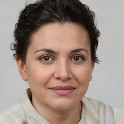 Joyful white adult female with short  brown hair and brown eyes