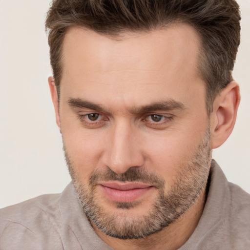 Joyful white adult male with short  brown hair and brown eyes