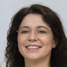 Joyful white adult female with long  brown hair and brown eyes