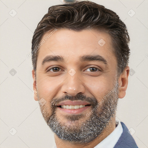 Joyful white young-adult male with short  black hair and brown eyes