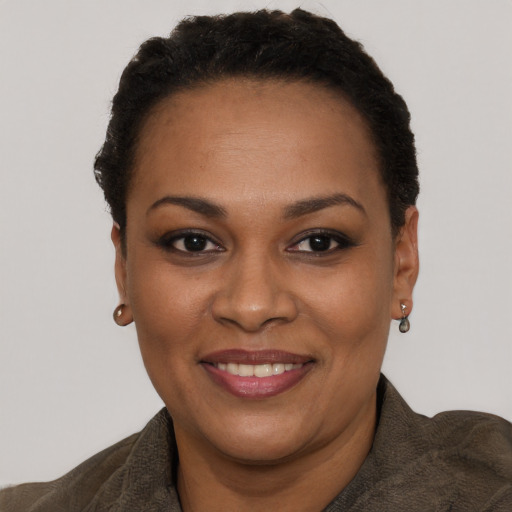 Joyful black adult female with short  black hair and brown eyes
