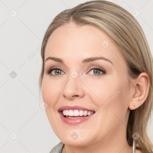 Joyful white young-adult female with medium  brown hair and blue eyes