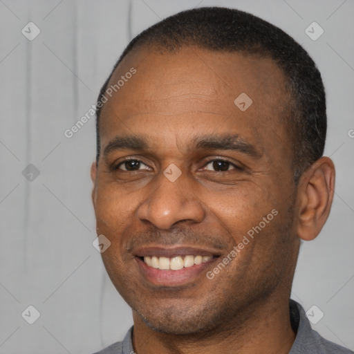 Joyful latino adult male with short  brown hair and brown eyes