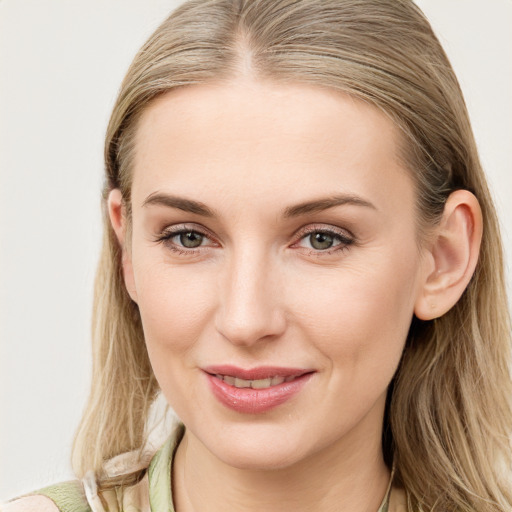 Joyful white young-adult female with long  brown hair and blue eyes