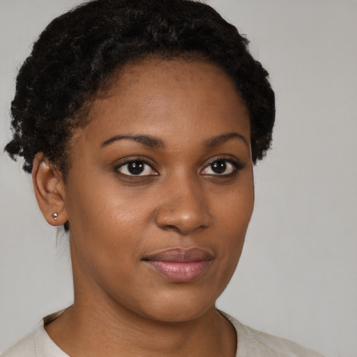 Joyful black young-adult female with short  brown hair and brown eyes