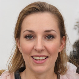 Joyful white adult female with medium  brown hair and blue eyes