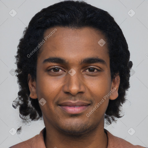 Joyful black young-adult male with short  black hair and brown eyes
