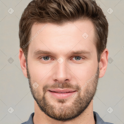 Joyful white young-adult male with short  brown hair and grey eyes