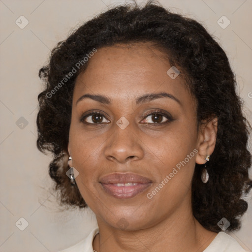 Joyful black adult female with medium  brown hair and brown eyes