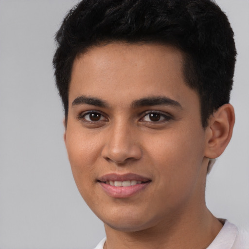 Joyful white young-adult male with short  black hair and brown eyes