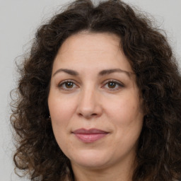 Joyful white adult female with long  brown hair and brown eyes