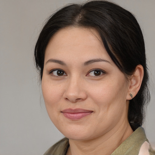 Joyful asian adult female with medium  brown hair and brown eyes