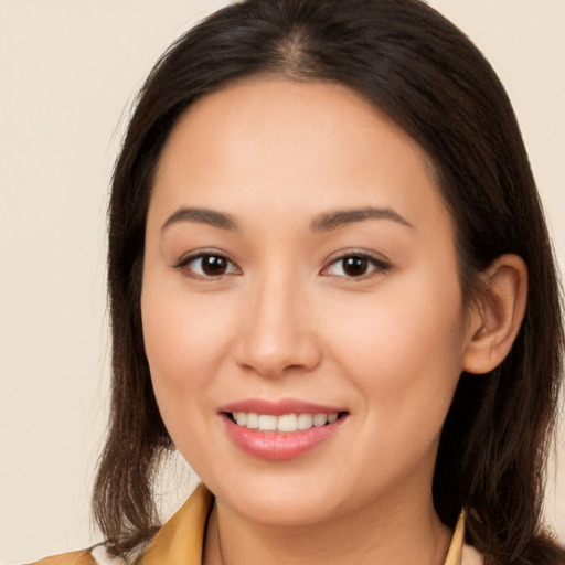 Joyful white young-adult female with long  brown hair and brown eyes