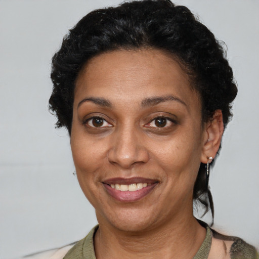 Joyful latino adult female with short  brown hair and brown eyes