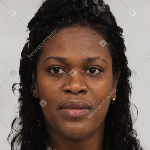 Joyful black young-adult female with long  black hair and brown eyes