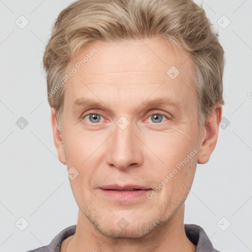 Joyful white adult male with short  brown hair and grey eyes