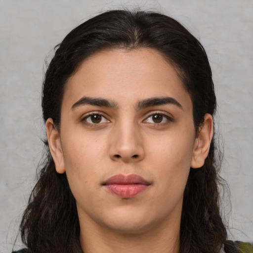 Neutral latino young-adult female with long  brown hair and brown eyes