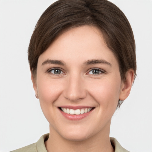 Joyful white young-adult female with short  brown hair and brown eyes