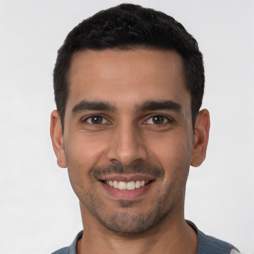 Joyful white young-adult male with short  black hair and brown eyes