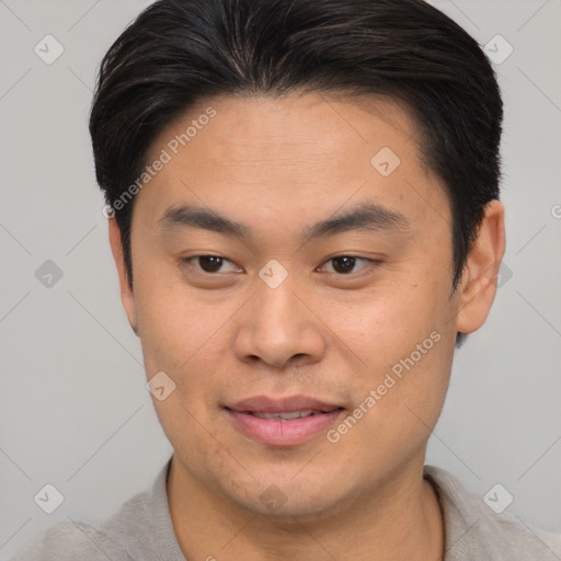 Joyful asian young-adult male with short  brown hair and brown eyes