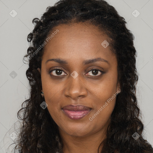 Joyful black young-adult female with long  brown hair and brown eyes