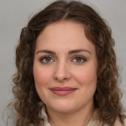 Joyful white young-adult female with medium  brown hair and green eyes