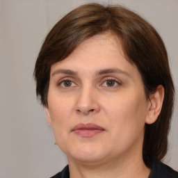 Joyful white adult female with medium  brown hair and brown eyes