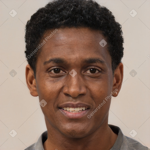 Joyful black young-adult male with short  black hair and brown eyes