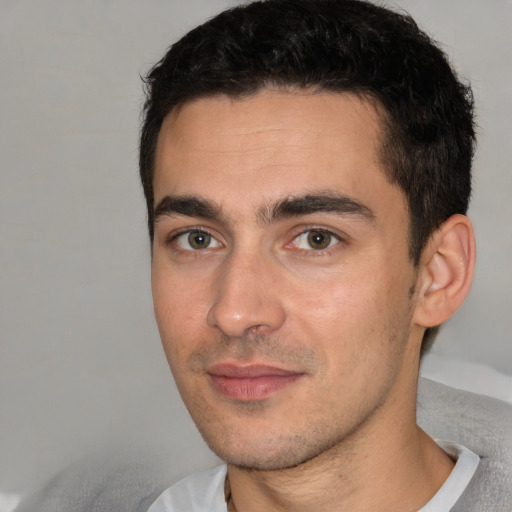 Joyful white young-adult male with short  black hair and brown eyes