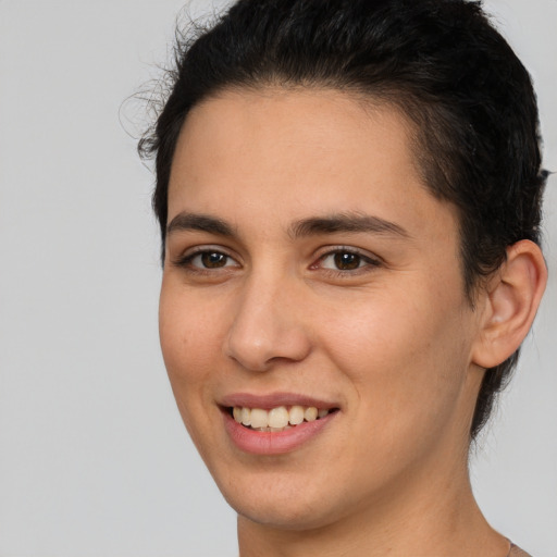 Joyful white young-adult female with short  brown hair and brown eyes