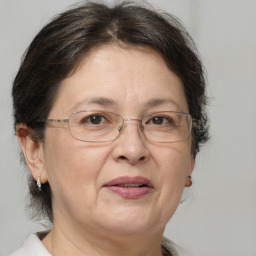 Joyful white middle-aged female with medium  brown hair and brown eyes