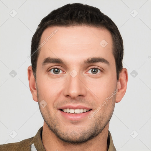 Joyful white young-adult male with short  brown hair and grey eyes