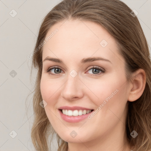 Joyful white young-adult female with long  brown hair and blue eyes