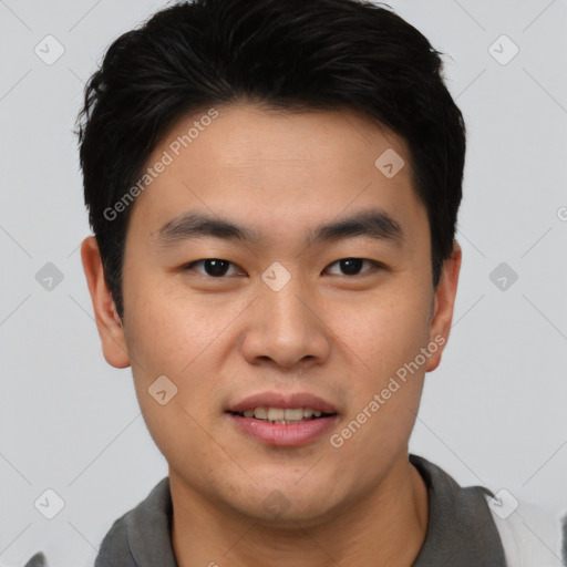 Joyful asian young-adult male with short  black hair and brown eyes