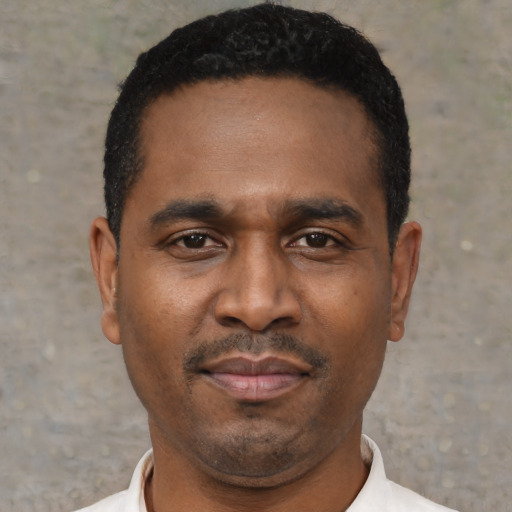 Neutral latino adult male with short  black hair and brown eyes
