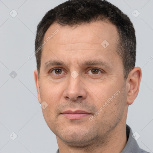 Joyful white adult male with short  brown hair and brown eyes