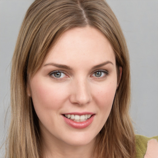 Joyful white young-adult female with long  brown hair and green eyes