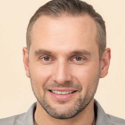 Joyful white adult male with short  brown hair and brown eyes