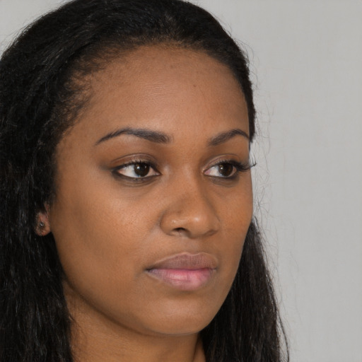 Neutral black young-adult female with long  brown hair and brown eyes