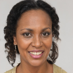 Joyful black adult female with medium  brown hair and brown eyes