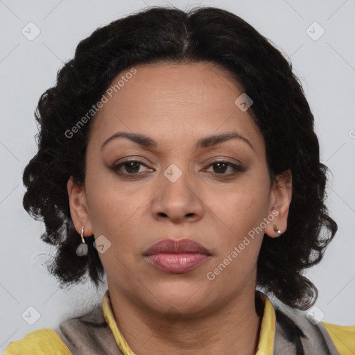 Joyful black adult female with medium  brown hair and brown eyes