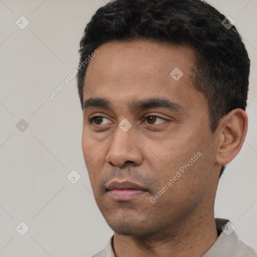 Neutral latino young-adult male with short  black hair and brown eyes