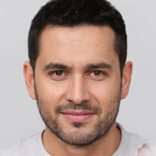 Joyful white young-adult male with short  brown hair and brown eyes