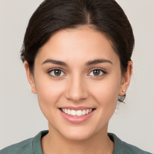 Joyful white young-adult female with medium  brown hair and brown eyes