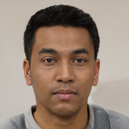 Neutral latino young-adult male with short  black hair and brown eyes