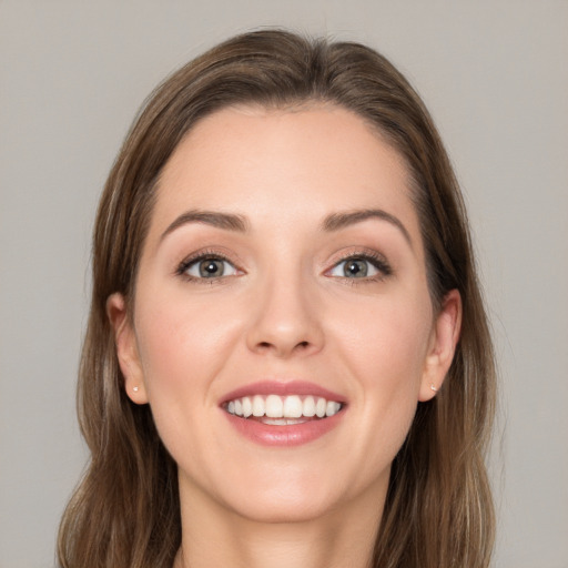 Joyful white young-adult female with long  brown hair and grey eyes