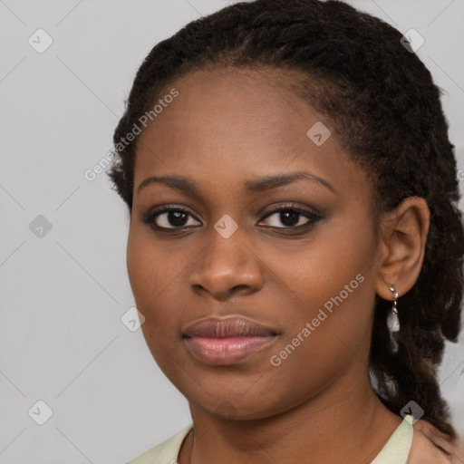 Joyful black young-adult female with long  brown hair and brown eyes