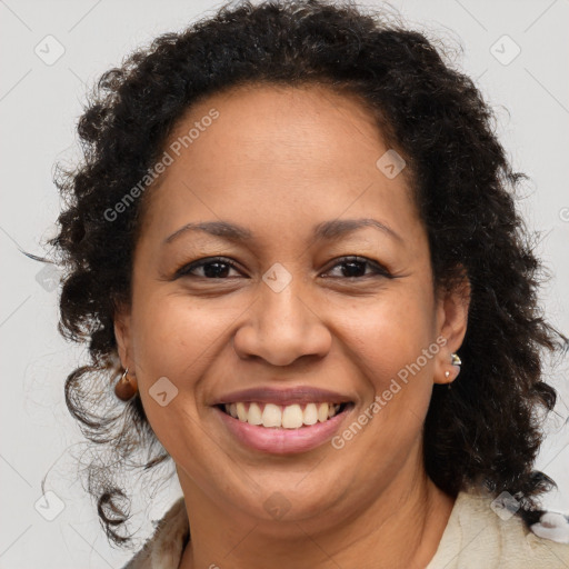 Joyful black adult female with medium  brown hair and brown eyes